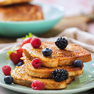 French toast on a plate with fresh berries