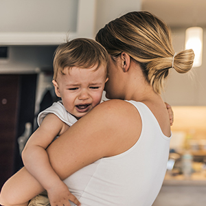 Woman holding crying infant