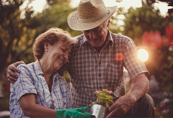Older couple in garden at sunset