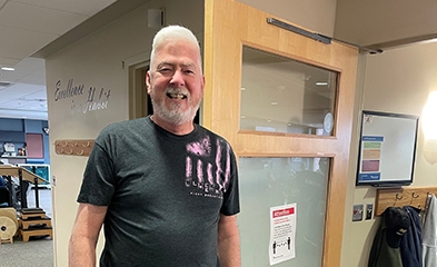Smiling patient walking out of rehab area