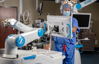 Healthcare provider working with surgical robot
