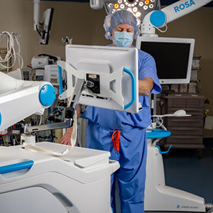 Healthcare provider working with ROSA surgical robot