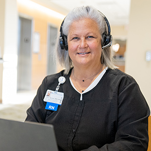 Nurse with headset at computer