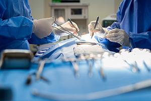 Surgeons in operating theater, focus on hands