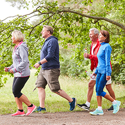 Four adults walking outdoors