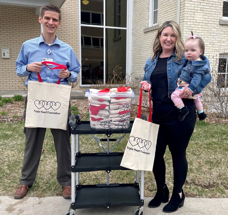 heather and daughter eva pose for a photo with their donation