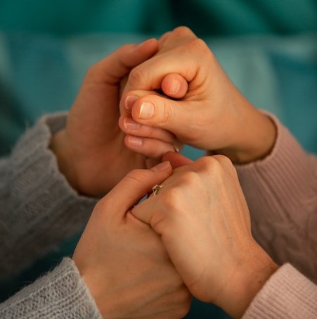 Two people holding hands