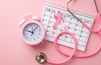 Calendar, clock, pink ribbon, and stethoscope; reminder to schedule an appointment