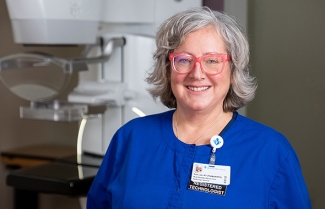 Mammographer in front of machine