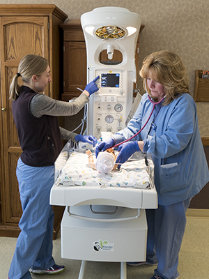 The Munson Healthcare care team with a newborn.