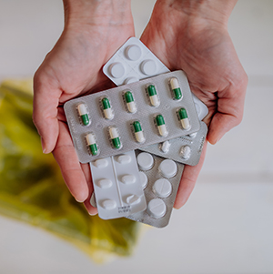 Hands holding blister packs containing pills