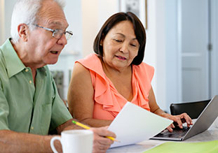 couple checking their bill for surprise billing