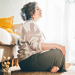 Woman sitting on floor meditating