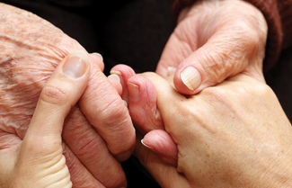 Older hands holding younger hands
