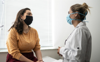 Patient speaking with provider in exam room