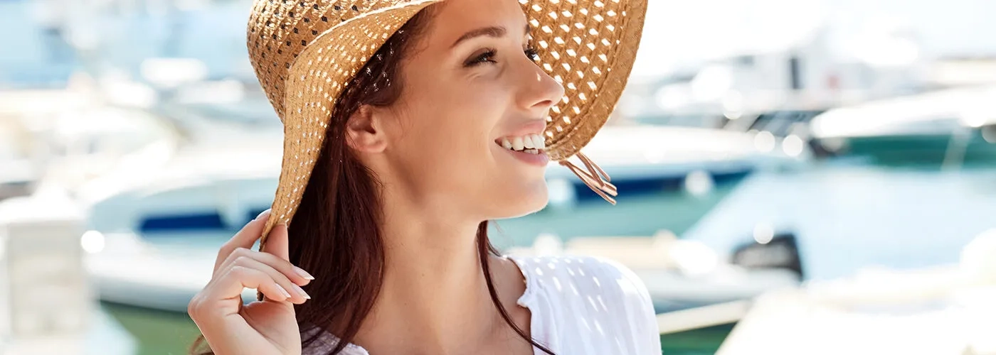 Smiling woman wearing sunhat