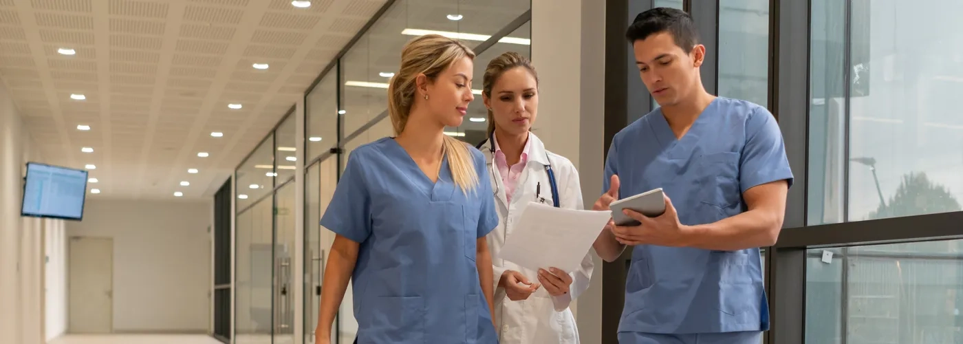 Healthcare team members talking in hallway